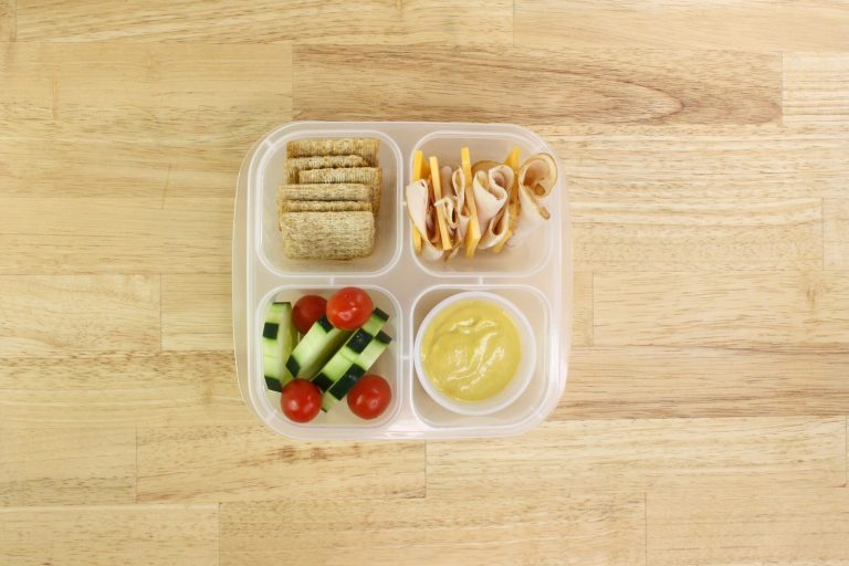 ADHD diet lunch box with whole-grain crackers, vegetables, and protein for a regular mealtime routine