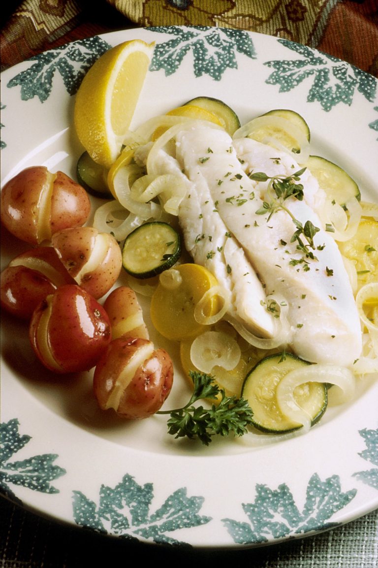 Baked fish with herbs and vegetables, a lower-sodium style CKD diet plate