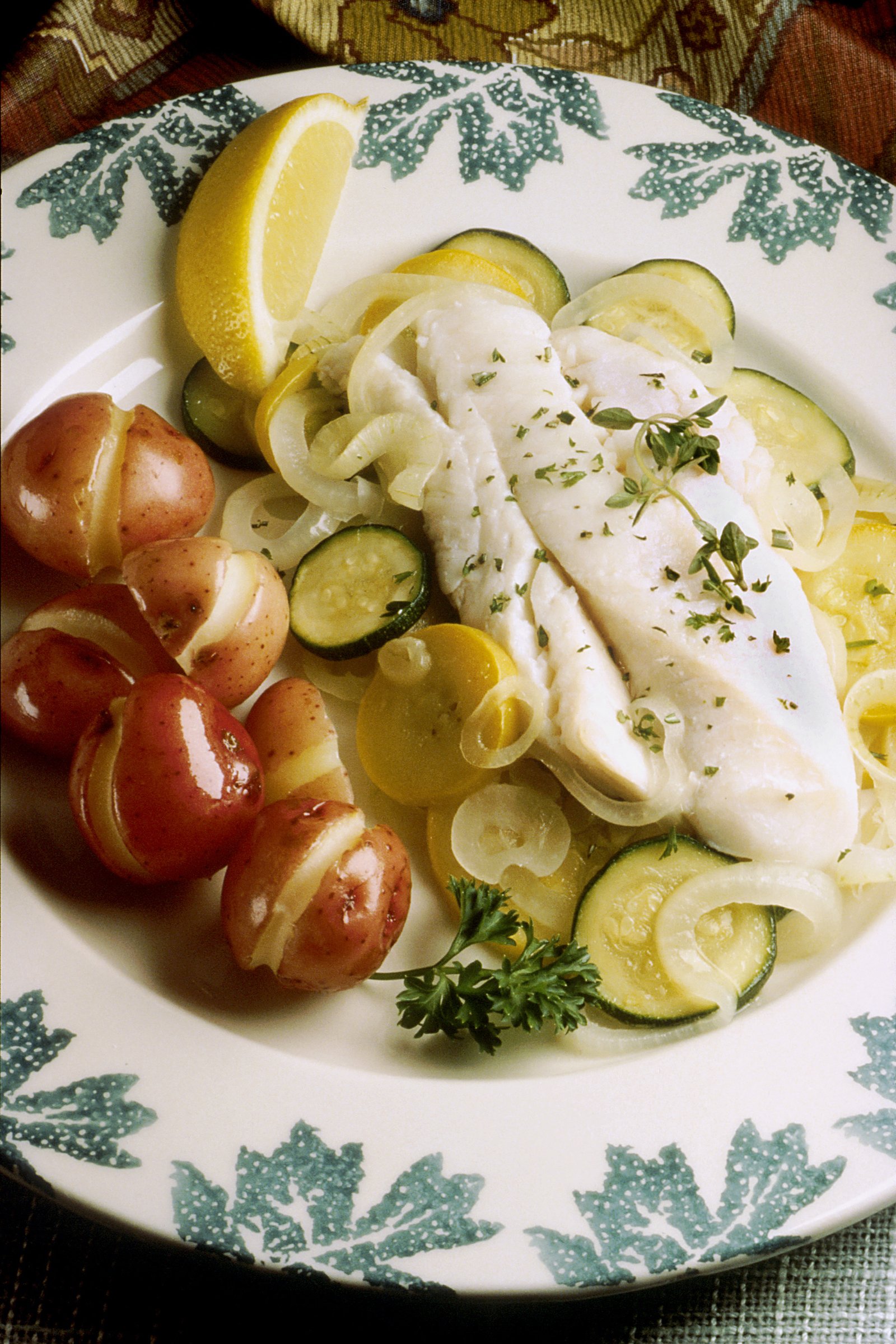 Baked fish with herbs and vegetables, a lower-sodium style CKD diet plate