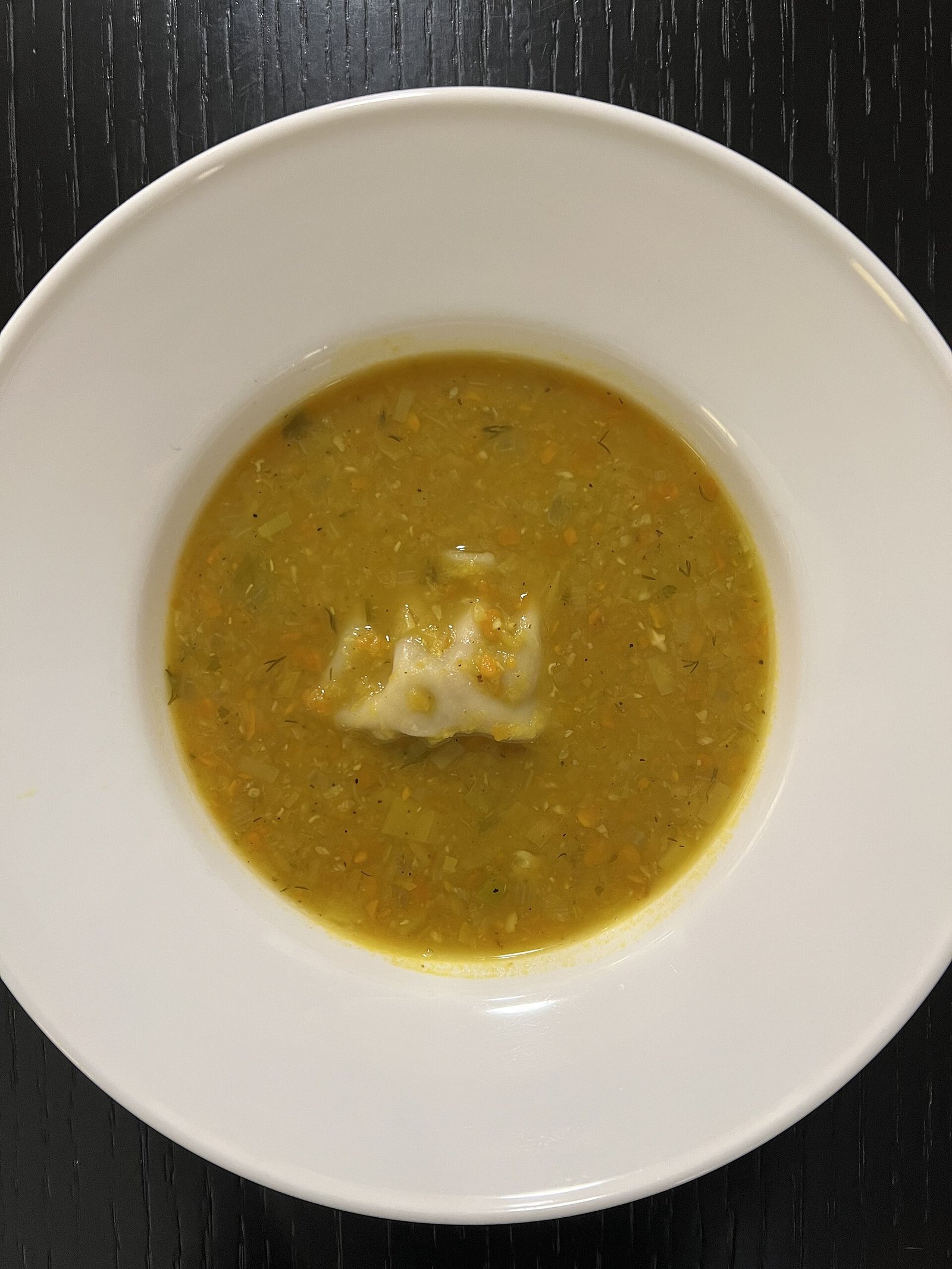 Smooth red lentil soup illustrating moist easy-to-eat meals while chewing is limited after dental implants