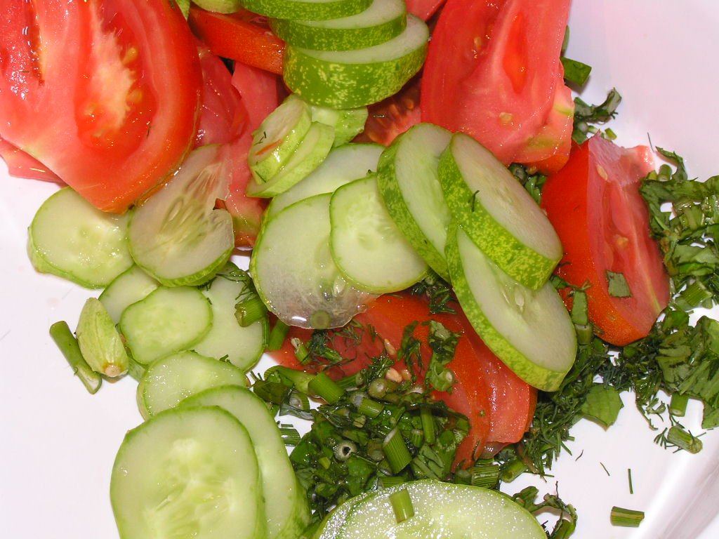 Tomato cucumber salad illustrating produce-forward plates with bladder-aware living