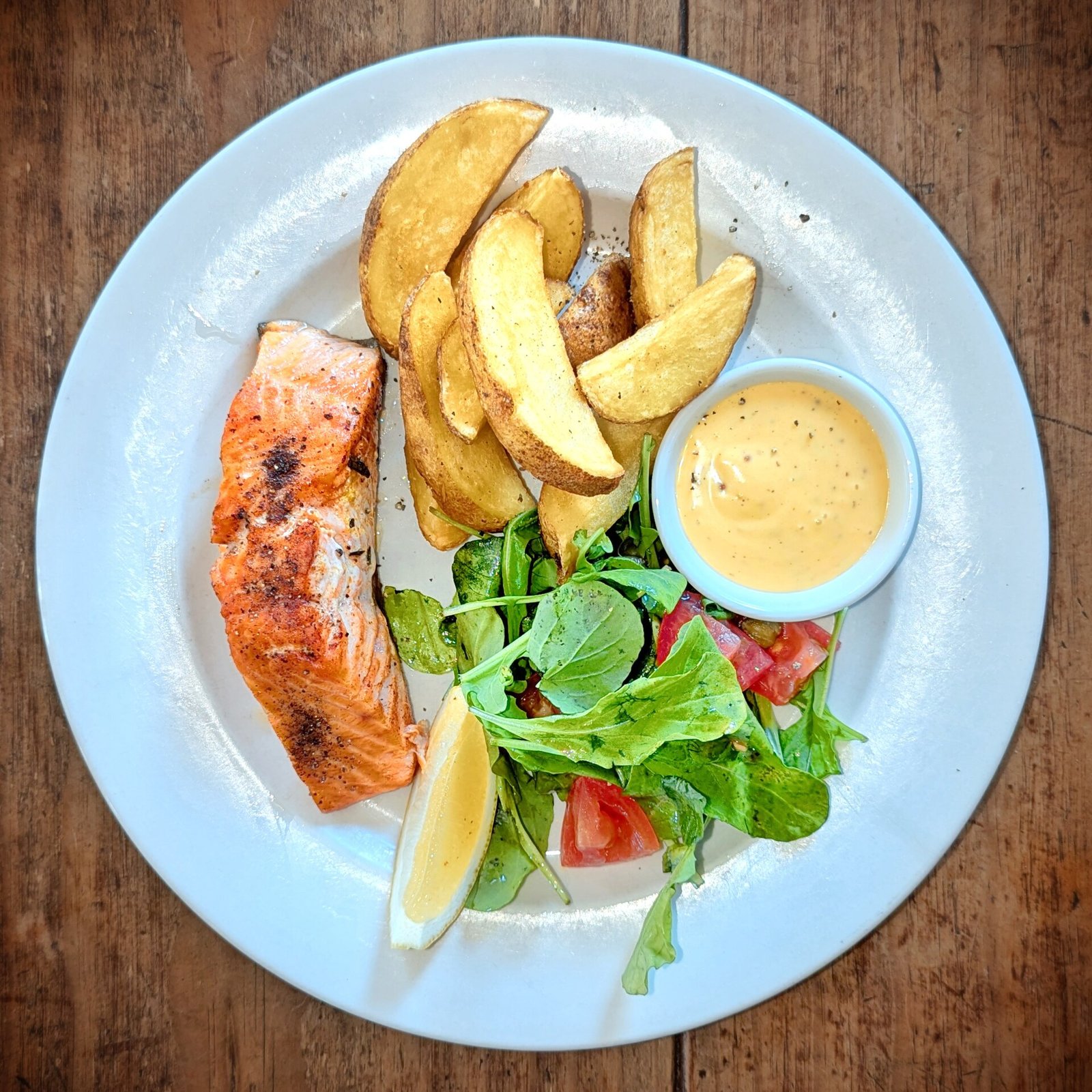 Grilled salmon with potato and salad as a protein-forward rehab meal