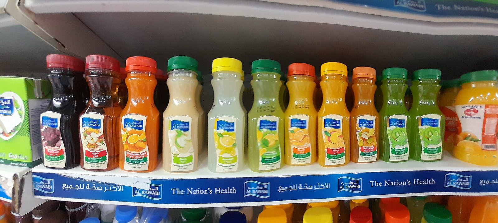 Fruit juice bottles on a supermarket shelf as high-fructose drinks to limit during flares