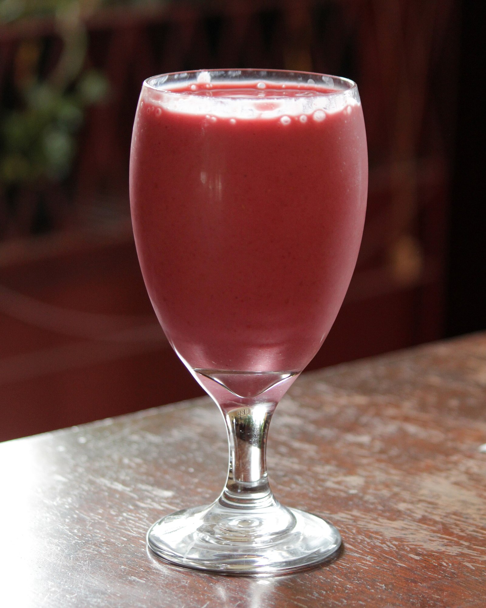 Glass of smooth strawberry smoothie, an easy liquid meal option on a gastroparesis diet