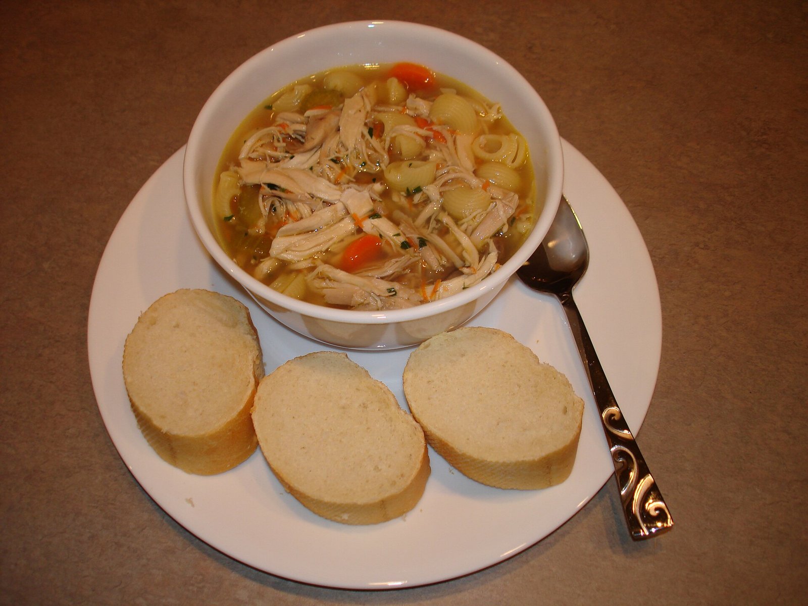 Chicken noodle soup bowl illustrating brothy easy protein after shingles
