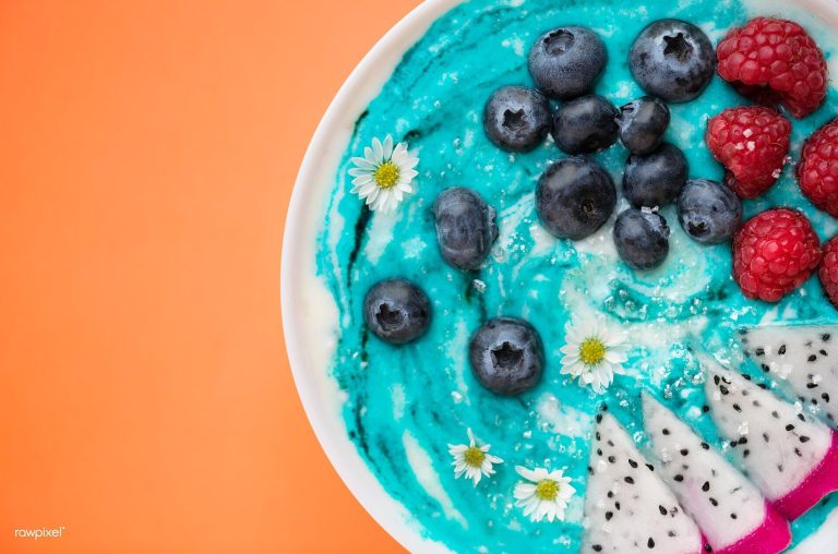 Endometriosis diet: smoothie bowl topped with blueberries, raspberries, and fruit