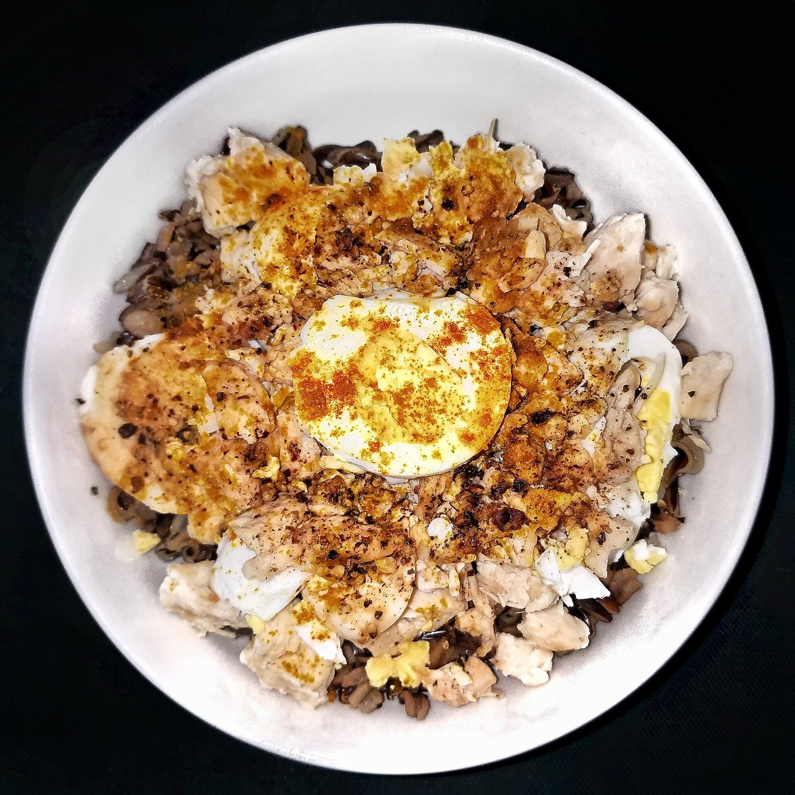 Wild rice bowl with chopped chicken breast and egg, a lean-protein meal for a pancreatitis diet